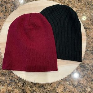 Two beanies. Maroon and black in color.